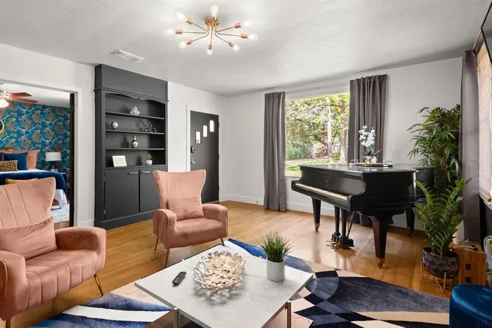 Capture the inviting essence of this home with a view from the living room to the front door, showcasing seamless design and warm hospitality right from the entrance.