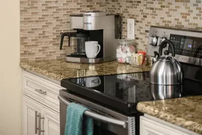 .Start your day right: Enjoy fresh coffee and effortless cooking in our sleek kitchen space