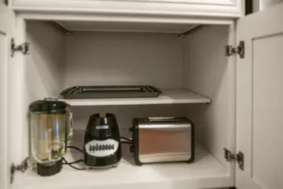 Fully equipped: Toaster, kettle, and blender neatly arranged inside the kitchen cabinet for all your needs