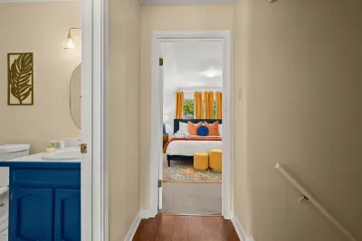 Vibrant comfort: The third bedroom features sunny yellow curtains and lively orange and red pillows