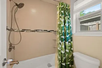 Nature-inspired elegance: Relax beneath a serene shower curtain adorned with lush green leaves