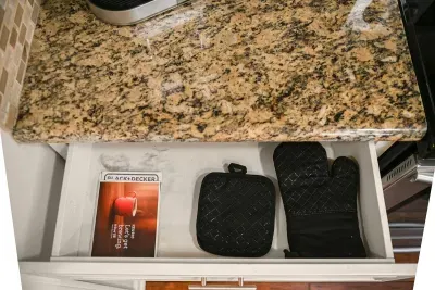 Practical touch: Kitchen gloves neatly stored in the drawer for your cooking convenience