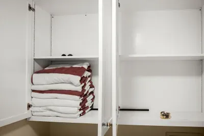 Fresh and ready: Clean towels neatly arranged in the closet for your convenience.