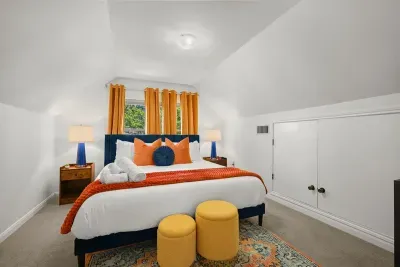 Bright and fluffy decor make this King bedroom a dream.