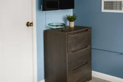 Timeless charm: The wood drawer table adds classic elegance and functionality to the bedroom