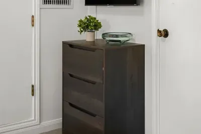 Charming detail: The wood drawer is beautifully complemented by a stylish plant
