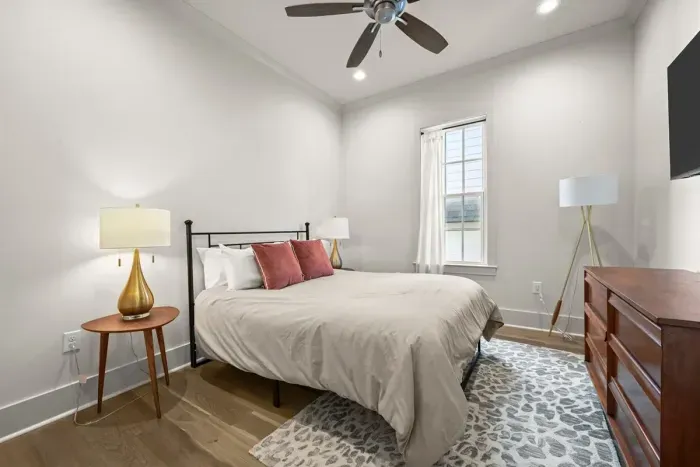 Stylish and serene bedroom with cozy touches, perfect for unwinding after a day of exploring