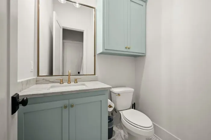 Elegant half bathroom with modern touches.