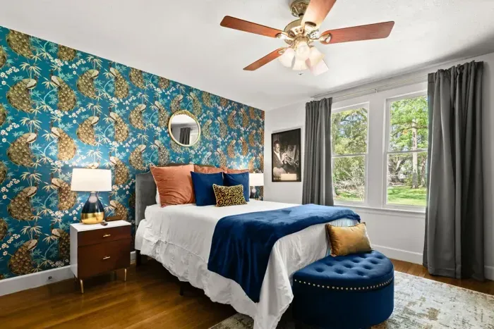 Guest Suite! Drift into a realm of tranquility on this relaxing bed adorned with soothing shades of blue and green, offering a soft haven