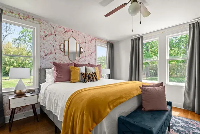 The master bedroom has some amazing color throughout with gorgeous windows all around.