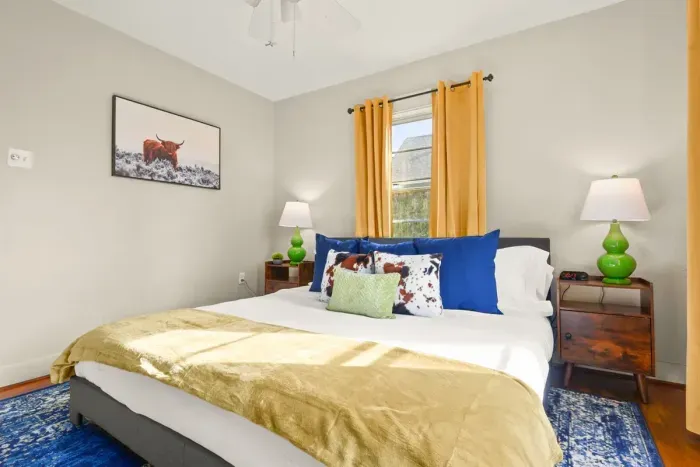 The allure of the bedroom in this home, adorned with beautifully designed curtains