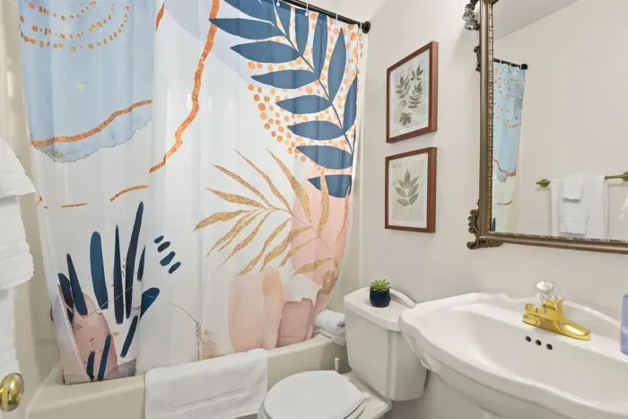 A luxurious experience in the bathroom of this home, adorned with decor essentials that elevate both style and enjoyment.