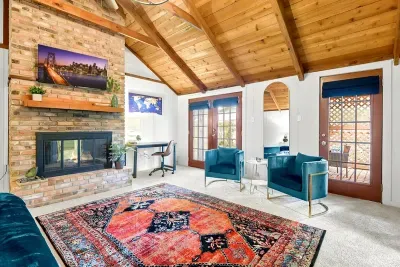 This charming home boasts a warm and inviting atmosphere with its exquisite wooden design furnishings, creating a cozy ambiance that perfectly complements the stylish chairs, adding a touch of