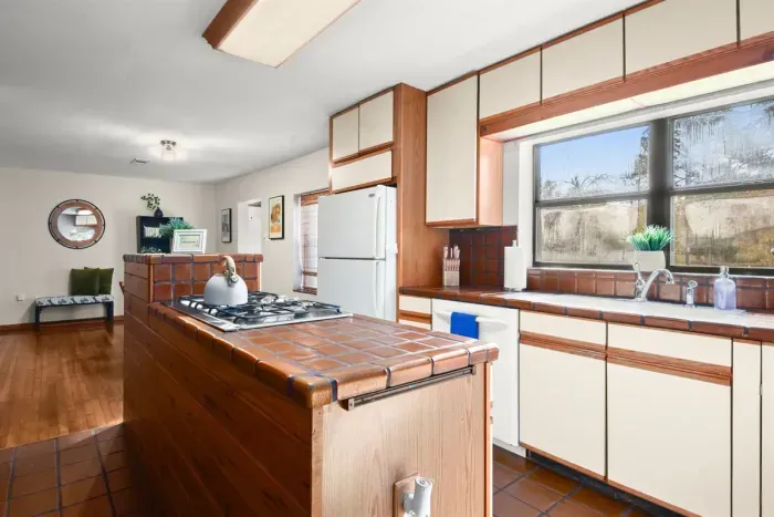 Delight in the culinary possibilities of a spacious kitchen, fully equipped with essentials, inviting you to enjoy and have fun while preparing meals in the heart of this welcoming home.