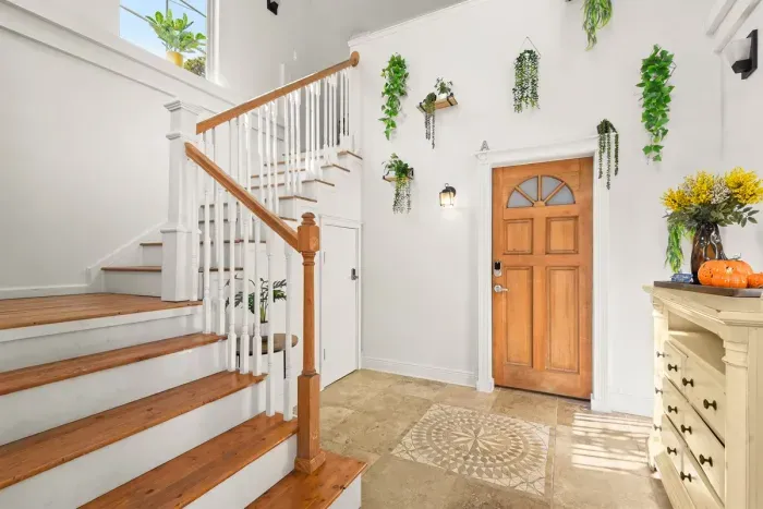 A spacious, light-filled entryway with charming details and an open staircase that sets the tone for a relaxing stay.