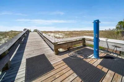 Outdoor shower to knock off that sand before jumping into the pool!