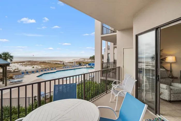Balcony view overlooking pool & ocean. Notice the recliner perfectly situated for ocean views, reading or naps.  