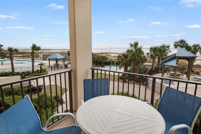 Balcony view overlooking splash pad, pool, bay pass & ocean.
