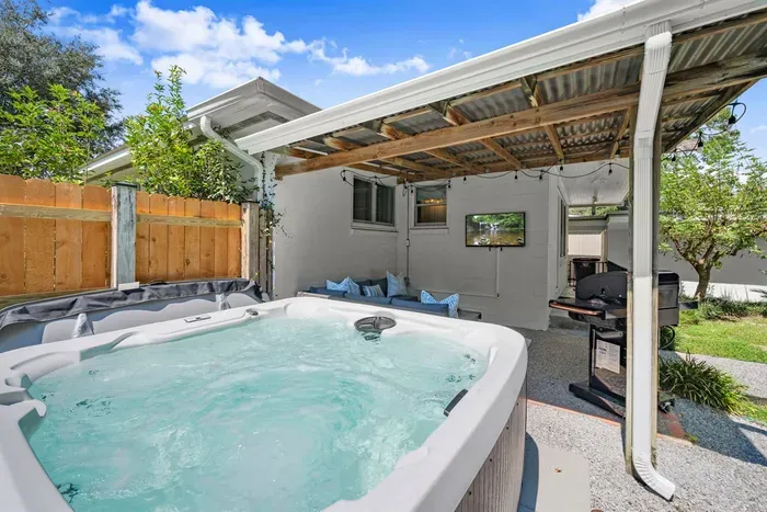 Backyard Oasis: Unwind in the hot tub and enjoy outdoor lounging under the stylish pergola!
