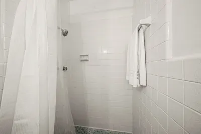 Shower Retreat: Refresh in this bright, tiled oasis with modern fixtures and fresh towels!