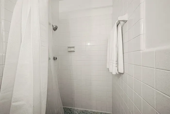 Shower Retreat: Refresh in this bright, tiled oasis with modern fixtures and fresh towels!