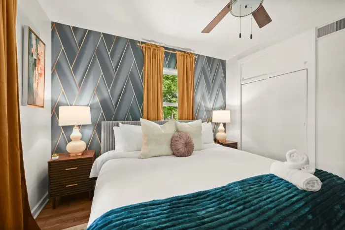 Bedroom Retreat: Stylish room with chic decor, plush bedding, and abundant natural light!