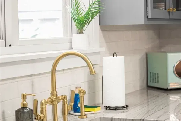 Kitchen Oasis: Bright, stylish space with gold accents and modern appliances for culinary adventures!