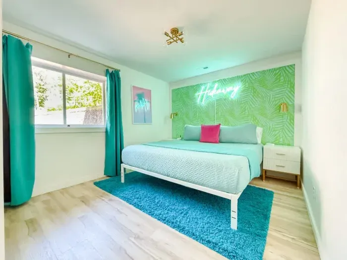 Island style KING size bed with dual nightstands, plenty of Underbed storage space & closet hanging space + mirror dresser on opposite wall. 