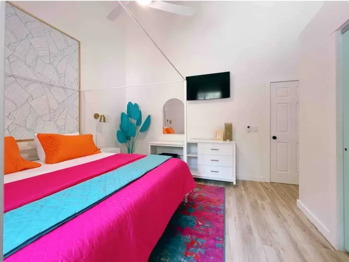 Main Level Bedroom also provides plenty of natural light with oversized window, equipped with 100%  blackout curtains. workspace/vanity  + Dresser. Roku Tv, King Size Canopy Bed, Closet & Full -Size mirror + 2 bedside vanities & 14" underbed storage