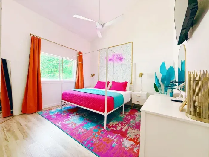 Main Level Bedroom also provides plenty of natural light with oversized window, equipped with 100%  blackout curtains. workspace/vanity  + Dresser. Roku Tv, King Size Canopy Bed, Closet & Full -Size mirror + 2 bedside vanities & 14" underbed storage