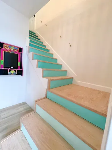 A colorful staircase connecting the levels with Ms. Pacman arcade game for fun! Stay & Play !
