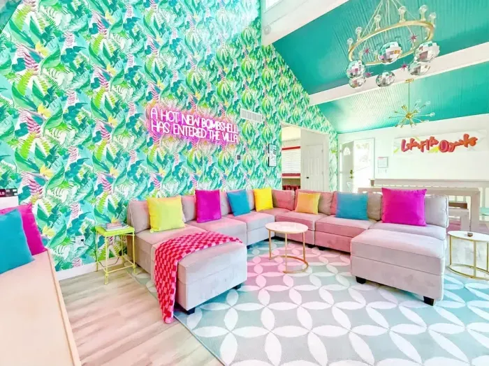 Alternative view of Great Room! Front Door far side w/18' ceilings & oversized new,comfortable modular sofa. Behind is the dining area w/seating for 8  & the right opens to the upper deck w/an extra 8 stools & dining ledge viewing the private dock.