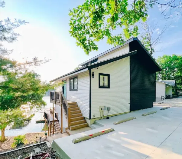 Alternate view of The Palm Lake Ozark featuring the front entrance w/ plenty of lighting, parking (for 4-5 cars -depending on size & only a few stairs for entry- which is exceptional for a lake property!)