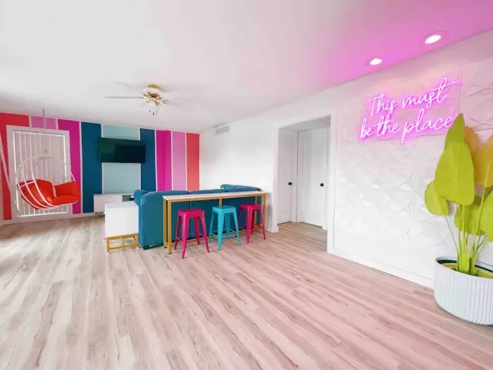 Hello selfie wall! The custom neon wall, hanging chair, bar seating, new modular sofa sectional, Roku tv, board games, corn hole, Mrs. Pacman, etc. makes for the perfect space to hang with family, friends or both! 