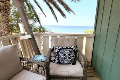 Enjoy this breezy balcony retreat with cozy wicker seating, ocean views, and warm coastal light. Perfect for morning coffee or sunset unwinding, offering a peaceful outdoor nook that blends comfort, style, and a relaxing seaside atmosphere.