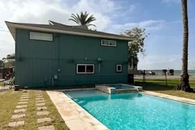 Relax in this private backyard escape featuring a sparkling pool, attached spa, spacious stone deck and lush fenced lawn. Perfect for sunny afternoons, family fun and peaceful evenings in a comfortable outdoor setting designed for effortless leisure.