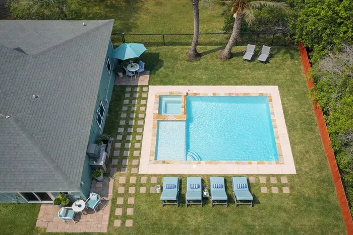Palm-Framed Pool Retreat w/ Tub, Loungers & Grassy Yard — Walk to Beach & Dining