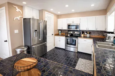 Modern Kitchen with Stainless Steel Appliances, Double Sink, Designer Tilework & Ample Storage — Perfect for Extended Stays or Weekend Getaways
