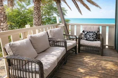 Oceanview Balcony with Cozy Seating – Steps from the Beach, Palm-Fringed Privacy, and Serene Mornings Await