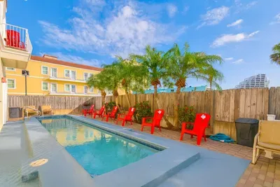 Private Tropical Pool Paradise
Refreshing private pool oasis awaits! Lounge on red Adirondack chairs amid swaying palms under sunny skies. Fenced backyard bliss, perfect for cooling off after beach days. Ultimate relaxation spot!