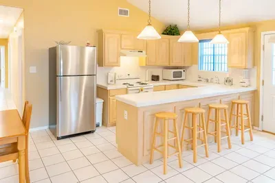 Warm & Spacious Kitchen Retreat – Stainless Appliances, Breakfast Bar, Natural Light, Dining Nook, and Easy Access to Patio & Living Areas. Perfect for Family Stays or Group Getaways.
