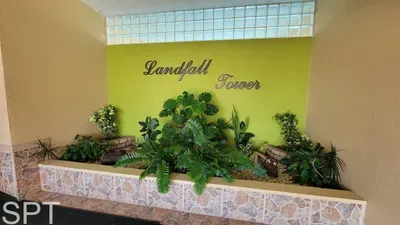 Welcoming building entry featuring vibrant greenery, warm lighting, and a clean, inviting aesthetic that sets the tone for a comfortable stay. A bright, well‑kept lobby area that offers guests a pleasant first impression upon arrival.