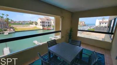 Relax on this covered waterfront balcony featuring a stylish dining setup, coastal breezes, and peaceful canal views. Perfect for morning coffee, sunset meals, and unwinding with a serene backdrop just steps from the shoreline.