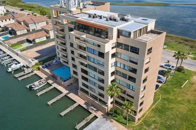 Waterfront condo with pool, boat slips & scenic canal views—steps from marina, minutes to beach. Spacious balconies, modern amenities, and resort-style relaxation in prime South Padre Island location.