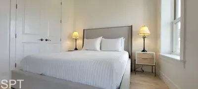 Elegant, sunlit bedroom featuring crisp white décor, plush bedding, and seamless indoor‑outdoor flow. Step onto your balcony and enjoy tranquil tropical views.