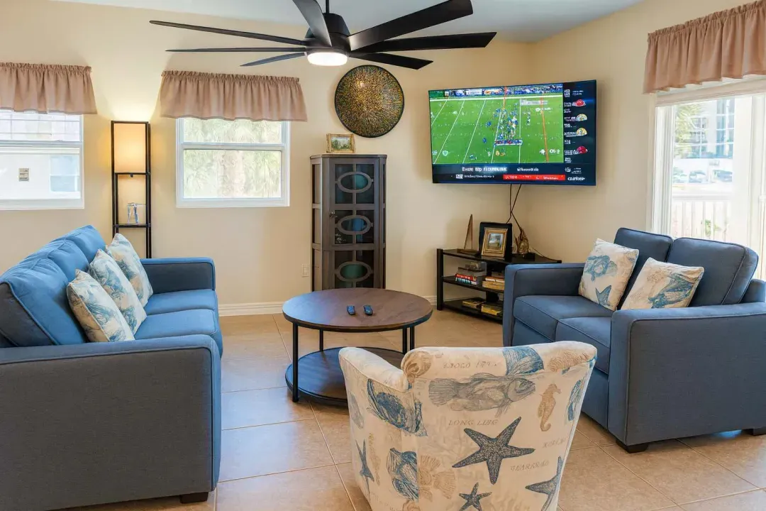 Cozy Beachy Living Room Lounge
Plush gray sofas, seashell chairs, 55" TV for game days under ceiling fan! Coastal decor, natural light—relax in SPI style at 113 E Pompano St. Steps to beach & launchpad views. Your home base!