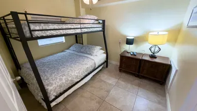 Fun Bunk Bed Kids' Room Nook
Spacious bunk beds for family adventures! Cozy gray bedding, lamps, wood nightstands—bright SPI sleep spot at 113 E Pompano St. Close to beach fun & SpaceX excitement. Dream big by the Gulf!