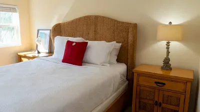 Tropical Rattan Bedroom Escape
Elegant rattan headboard, red accent pillow, bedside lamps—cozy luxe in SPI sunshine! Near 113 E Pompano St, beach access & SpaceX launchpad. Perfect for romantic Gulf getaways & restful nights.