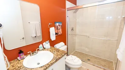A warm, tidy bathroom with clean lines and a simple, welcoming layout. Soft lighting, organized touches, and a calm color palette create an easy, refreshing space that feels comfortable and well‑kept for everyday routines.