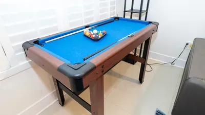 A fun, casual game corner with a bright blue table and simple, relaxed setup that invites easy downtime. Clean lines, natural light, and an open layout create a welcoming spot for guests to unwind and enjoy a laid‑back break together.